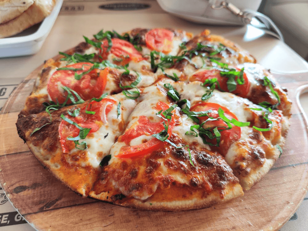 Close-up of a Margherita pizza with fresh tomatoes and basil — a classic style at the heart of the best pizza in New York