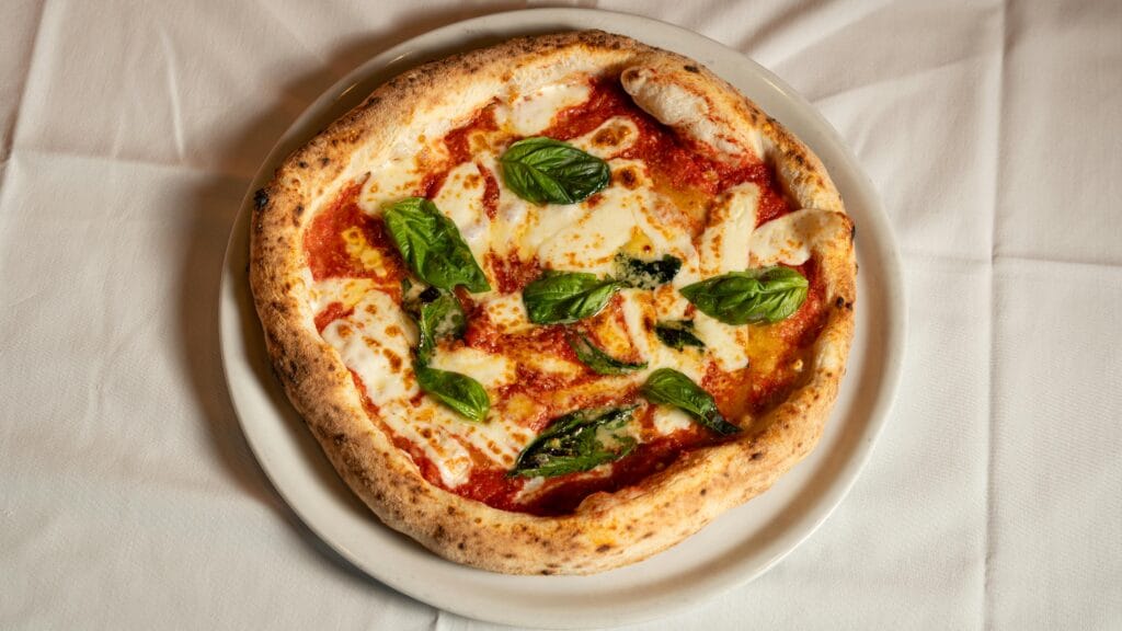 Neapolitan pizza with leopard-spotted crust, fresh basil, and buffalo mozzarella — a staple of the best pizza in New York scene